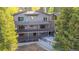 Multi-level deck and patio area overlooking a serene backyard with mature trees, ideal for outdoor living at 537 Moonstone Rd, Breckenridge, CO 80424
