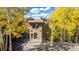 Charming two-story home featuring well-maintained landscaping and a welcoming entrance surrounded by colorful trees at 537 Moonstone Rd, Breckenridge, CO 80424