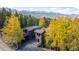 Two-story home surrounded by lush trees, a private driveway, and an expansive deck in a mountain setting at 537 Moonstone Rd, Breckenridge, CO 80424