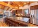 This rustic kitchen features stone fireplace, wooden beams and a long breakfast bar perfect for entertaining at 537 Moonstone Rd, Breckenridge, CO 80424