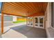 Spacious back patio with a wood ceiling, a hanging light fixture, and view of the backyard at 6935 W 16Th Ave, Lakewood, CO 80214