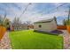Large backyard with artificial grass, string lights, ideal for outdoor gatherings and recreation at 6935 W 16Th Ave, Lakewood, CO 80214