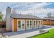 Backyard featuring string lights over a patio, artificial grass, and wood fencing at 6935 W 16Th Ave, Lakewood, CO 80214