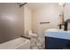 Stylish bathroom with gray tiled shower, patterned floor, and modern fixtures, including a sleek vanity at 6935 W 16Th Ave, Lakewood, CO 80214