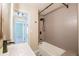 Modern bathroom featuring a tiled shower, tub, patterned floors, and a sleek vanity at 6935 W 16Th Ave, Lakewood, CO 80214