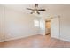 Bedroom with ceiling fan and sliding door to laundry; warm, natural light at 6935 W 16Th Ave, Lakewood, CO 80214