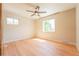 Bedroom featuring light hardwood floors, a ceiling fan, and large windows for ample natural light at 6935 W 16Th Ave, Lakewood, CO 80214