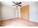 Bright bedroom with wood floors, ceiling fan, and a modern sliding blind at 6935 W 16Th Ave, Lakewood, CO 80214