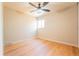 Well-lit bedroom featuring light hardwood floors, neutral walls, and a ceiling fan at 6935 W 16Th Ave, Lakewood, CO 80214