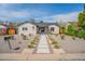 Charming home featuring fresh landscaping and a stone pathway leading to the front door at 6935 W 16Th Ave, Lakewood, CO 80214