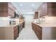 Modern kitchen showcasing brown cabinets, stainless steel appliances, and white subway tile backsplash at 6935 W 16Th Ave, Lakewood, CO 80214