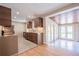 Modern kitchen adjacent to a sunroom featuring minimalist cabinetry, light counters and floors at 6935 W 16Th Ave, Lakewood, CO 80214