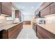 Open kitchen features custom cabinetry and modern appliances, with a view into the spacious living area at 6935 W 16Th Ave, Lakewood, CO 80214
