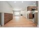 Bright and open living space with hardwood floors, complemented by modern cabinets and kitchen view at 6935 W 16Th Ave, Lakewood, CO 80214