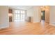 Spacious living area with hardwood floors, open floor plan, and view to an adjacent kitchen and doors to backyard at 6935 W 16Th Ave, Lakewood, CO 80214