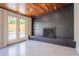 Cozy living space featuring dark tile fireplace, white floors and bright glass doors to backyard at 6935 W 16Th Ave, Lakewood, CO 80214