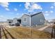 Backyard view of house and grill with large open field at 5035 Old Ranch Dr, Longmont, CO 80503