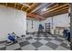 Basement with finished ceiling, exercise equipment, and black and gray tiled floor at 5035 Old Ranch Dr, Longmont, CO 80503