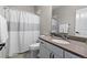 Functional bathroom showcasing a white shower curtain and neutral-toned countertop, providing a clean and practical space at 5035 Old Ranch Dr, Longmont, CO 80503