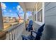 Covered front porch with blue Adirondack chairs and American flag at 5035 Old Ranch Dr, Longmont, CO 80503