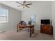 Home office with a ceiling fan, a work desk, and carpet flooring at 5035 Old Ranch Dr, Longmont, CO 80503