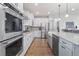 Modern kitchen featuring stainless steel appliances, white cabinets, and hardwood floors at 5035 Old Ranch Dr, Longmont, CO 80503