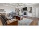 Cozy living room with coffered ceilings, fireplace, built-ins, and hardwood floors at 5035 Old Ranch Dr, Longmont, CO 80503