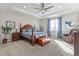 Spacious main bedroom with tray ceiling, large windows, and hardwood furniture at 5035 Old Ranch Dr, Longmont, CO 80503