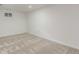An empty basement room with neutral carpet and white walls with a single window at 2026 S Pitkin St, Aurora, CO 80013