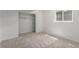 A basement bedroom with neutral carpet, closet, and a single window at 2026 S Pitkin St, Aurora, CO 80013