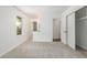 A bedroom with neutral carpet, a closet, and a view into the bathroom at 2026 S Pitkin St, Aurora, CO 80013