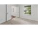 Bright bedroom with white walls, neutral carpet, and a window overlooking the outdoors at 2026 S Pitkin St, Aurora, CO 80013