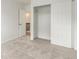 Bedroom featuring neutral carpet, white walls, and closet at 2026 S Pitkin St, Aurora, CO 80013