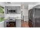 Stylish kitchen with granite countertops, stainless appliances, and a view into the living area at 2026 S Pitkin St, Aurora, CO 80013