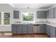 Well-lit kitchen with stainless steel appliances, granite countertops and gray cabinets at 2026 S Pitkin St, Aurora, CO 80013