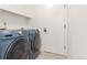 Laundry room featuring a modern washer and dryer set and white shelving at 2026 S Pitkin St, Aurora, CO 80013
