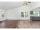 Open-concept living area with hardwood floors, high ceilings, and a view into the kitchen at 2026 S Pitkin St, Aurora, CO 80013