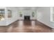Inviting living room with hardwood floors, a fireplace, and ample natural light through large windows at 2026 S Pitkin St, Aurora, CO 80013