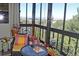Inviting sunroom featuring a table and chair set, surrounded by large windows with a scenic view of trees and mountains at 13890 E Marina Dr # 605, Aurora, CO 80014