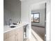 Stylish wet bar with metallic tile backsplash and a beverage cooler at 2391 King St, Denver, CO 80211