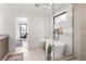 Bright bathroom boasts a soaking tub and seamless glass shower at 2391 King St, Denver, CO 80211