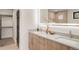 Modern bathroom with dual sinks, a vanity, and walk-in closet at 2391 King St, Denver, CO 80211