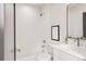 Modern bathroom featuring white subway tile, sleek vanity, and elegant fixtures at 2391 King St, Denver, CO 80211