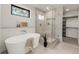 Modern bathroom featuring a soaking tub, glass shower, and stylish fixtures at 2391 King St, Denver, CO 80211