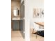 Modern bathroom with stylish wood-look tile wall, mirror, and vanity near dining room at 2391 King St, Denver, CO 80211