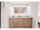 Modern bathroom with dual sinks, a vanity, and walk-in closet at 2391 King St, Denver, CO 80211