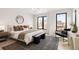 Light-filled bedroom with large windows and stylish contemporary furnishings at 2391 King St, Denver, CO 80211