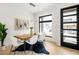 Modern dining room features a wooden table, white chairs, a cowhide rug, and a large window at 2391 King St, Denver, CO 80211