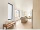 Open-concept entryway with bench and view into spacious kitchen and light-filled living area at 2391 King St, Denver, CO 80211