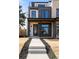 Modern multi-story home with a striking gray and white exterior and black framed windows at 2391 King St, Denver, CO 80211